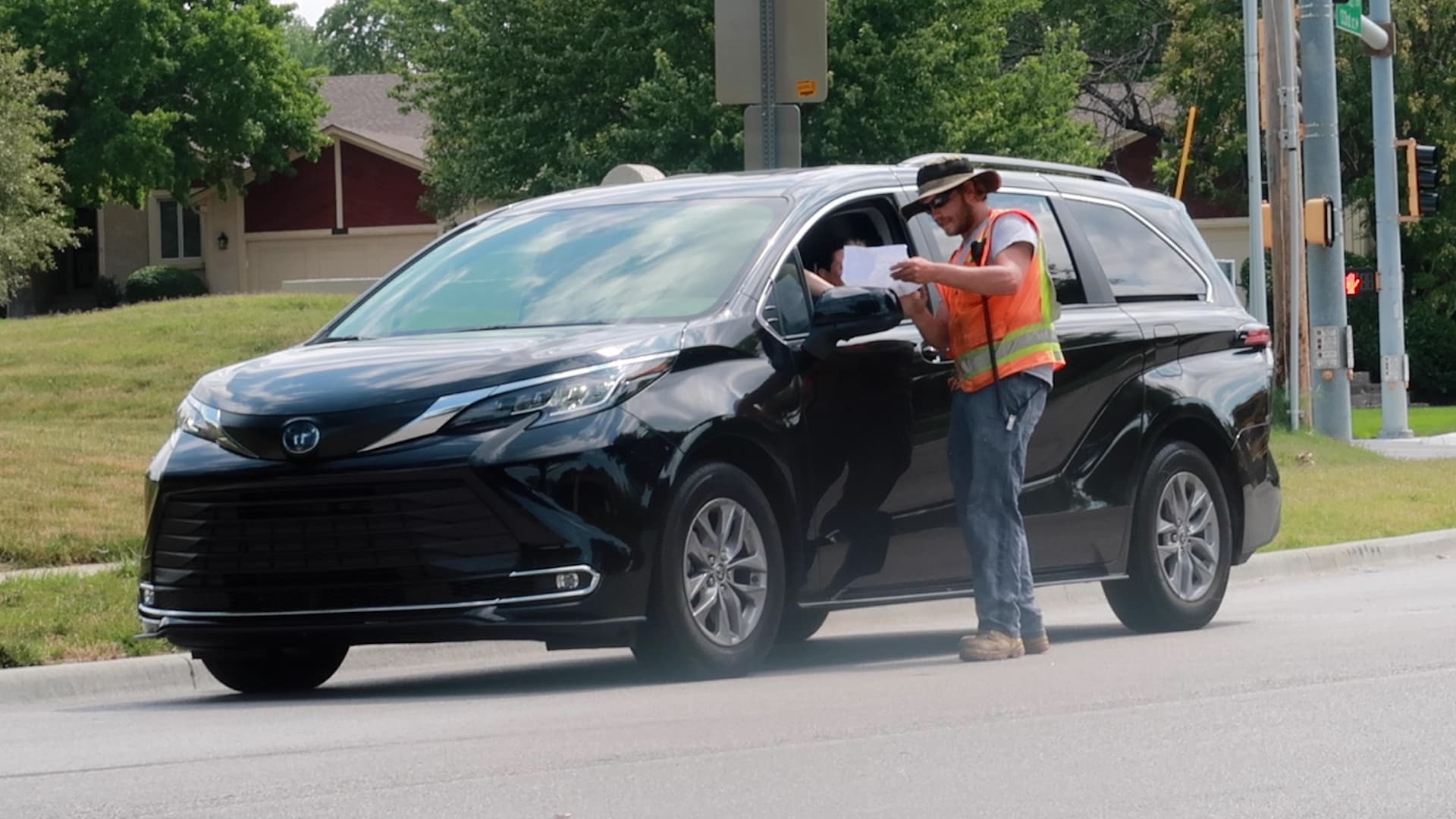 Flagger Giving Map Directions to Driver