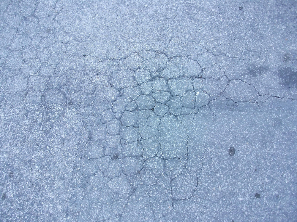large alligator cracking in asphalt